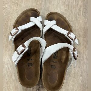 Girls Birkenstocks sandals.  White leather with rose gold hardware.